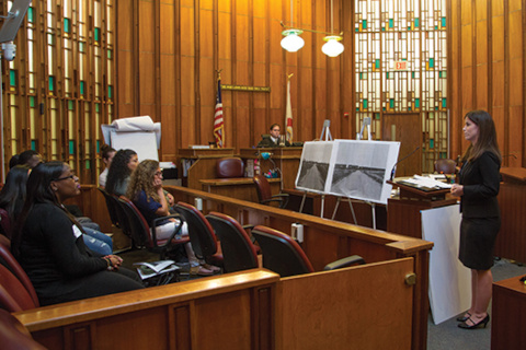 Lawyer addressing jury in courtroom